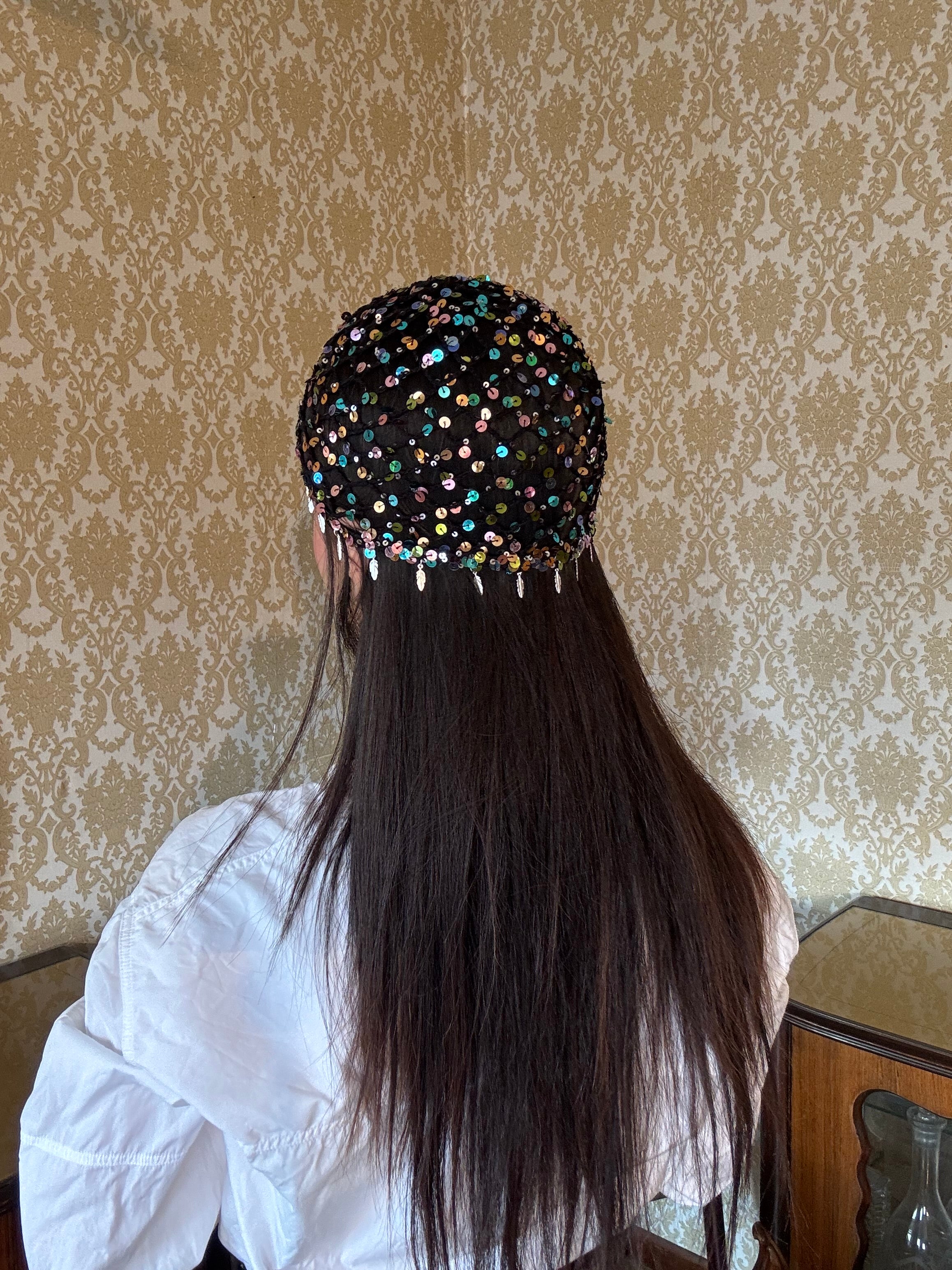Crochet glittered mesh hat with feathers