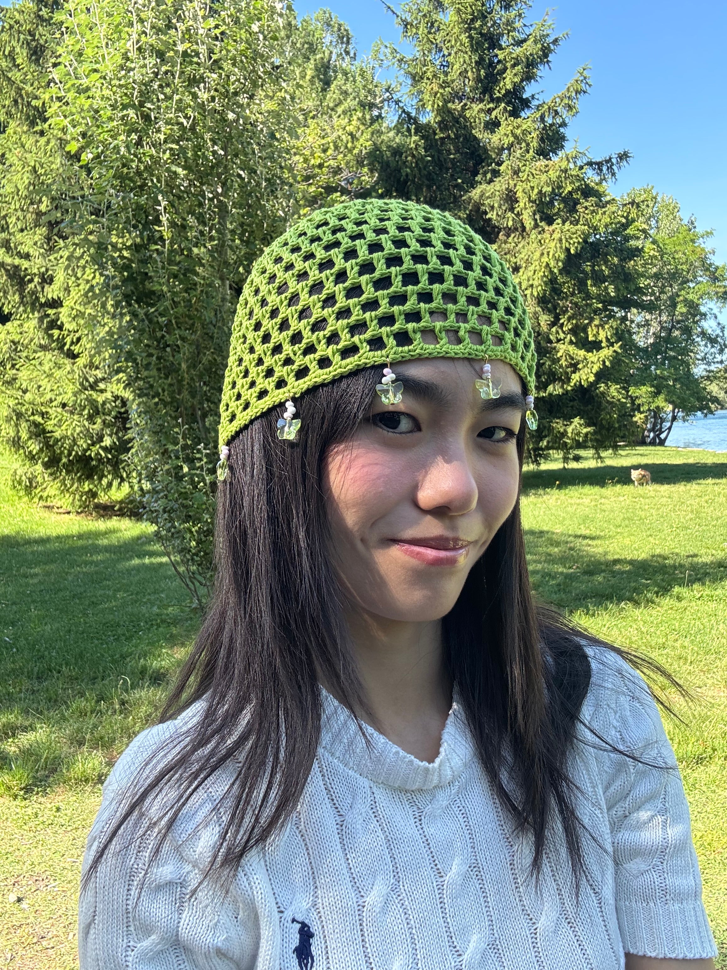 Crochet green mesh hat with butterflies