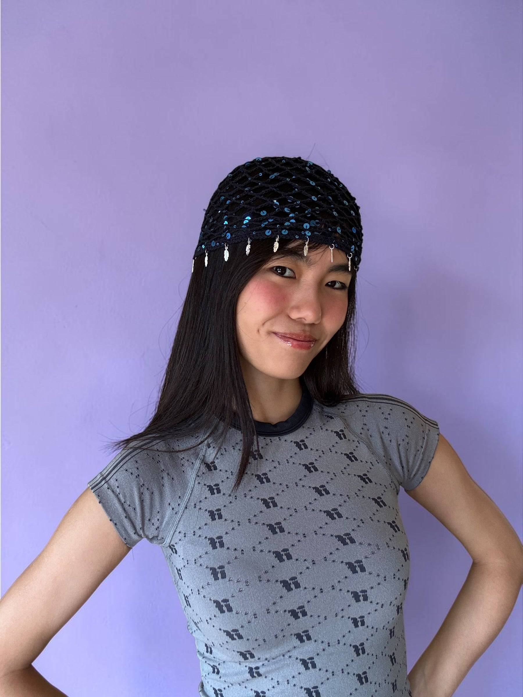 Crochet glittered mesh hat with feathers
