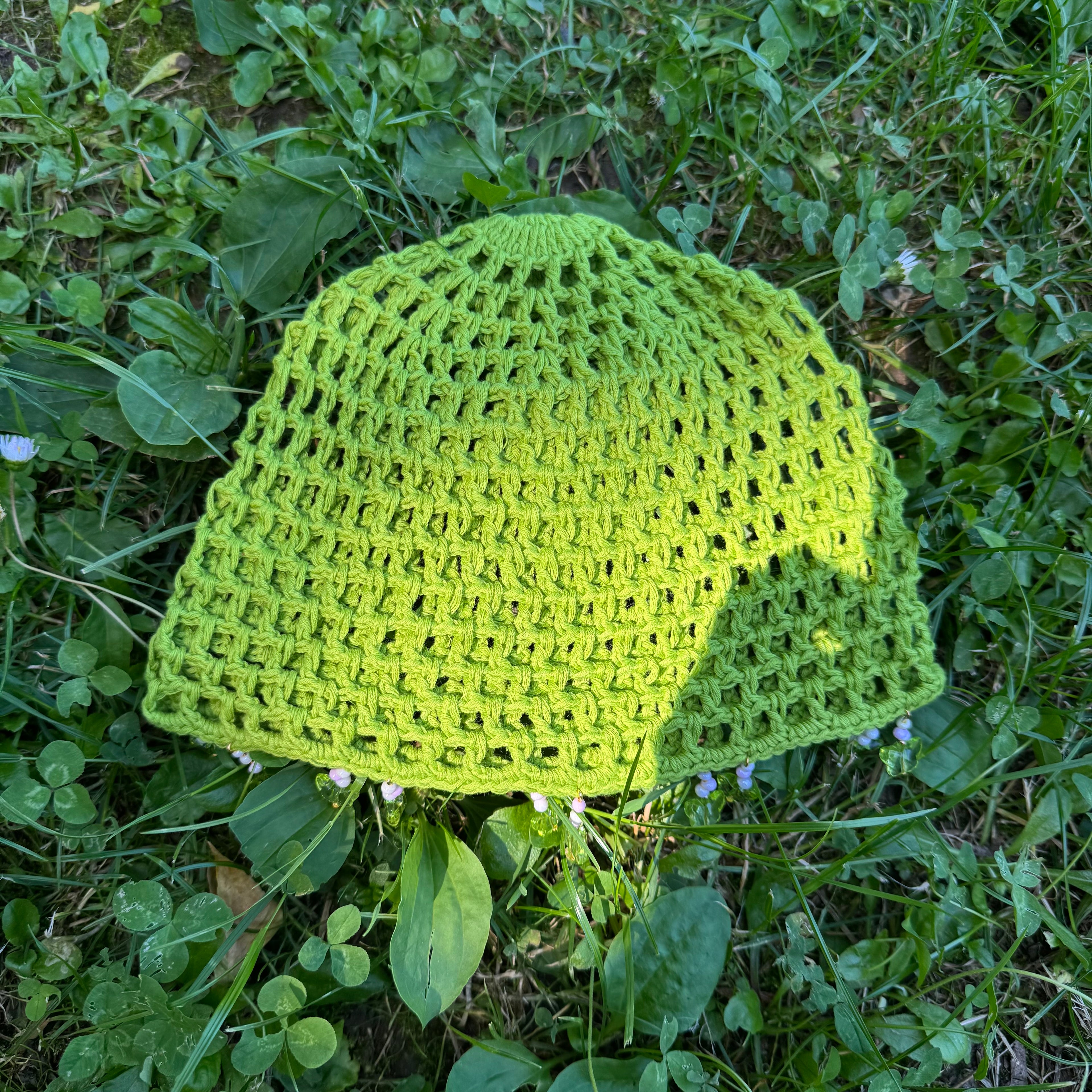 Crochet green mesh hat with butterflies