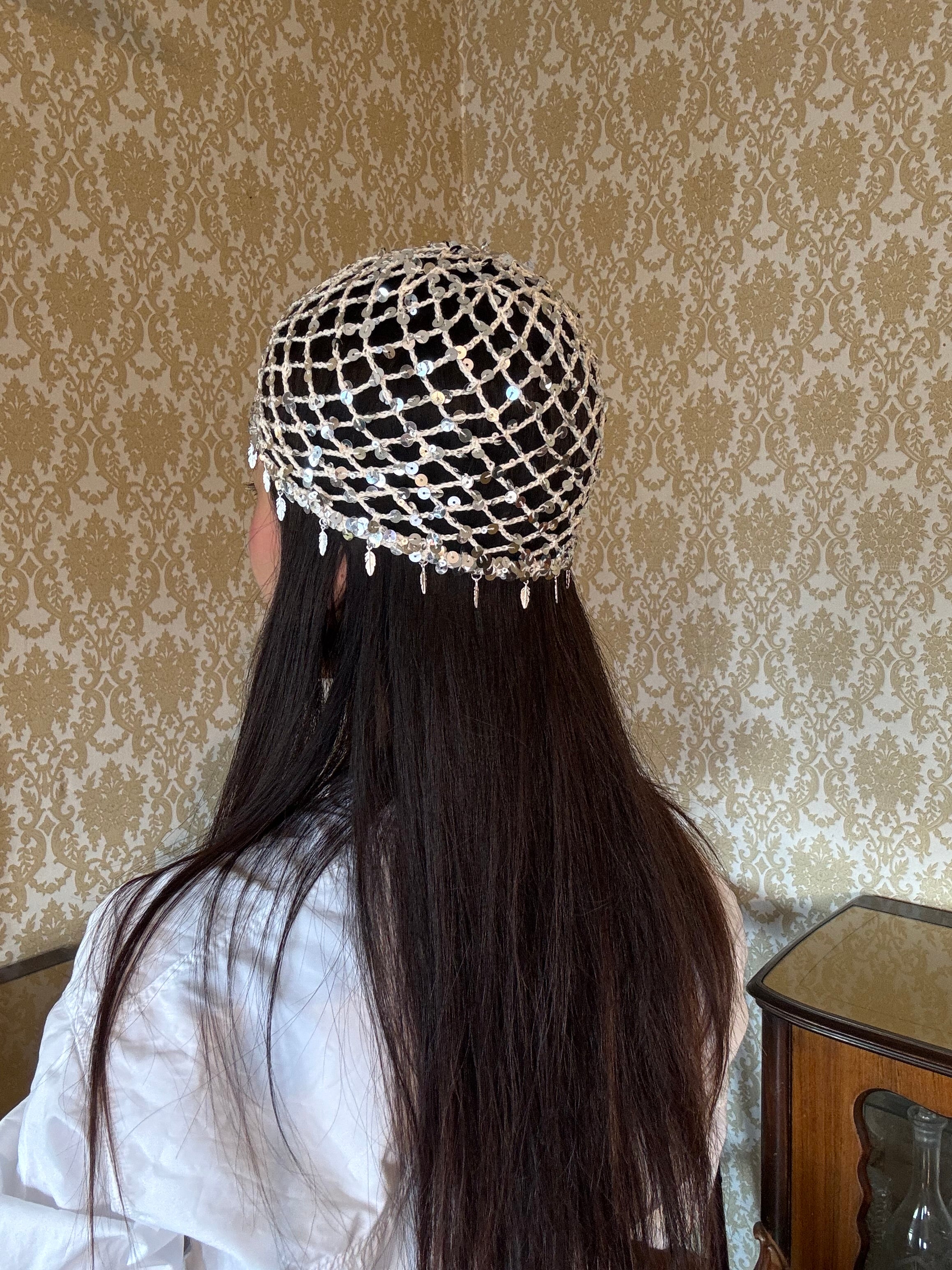 Crochet glittered mesh hat with feathers